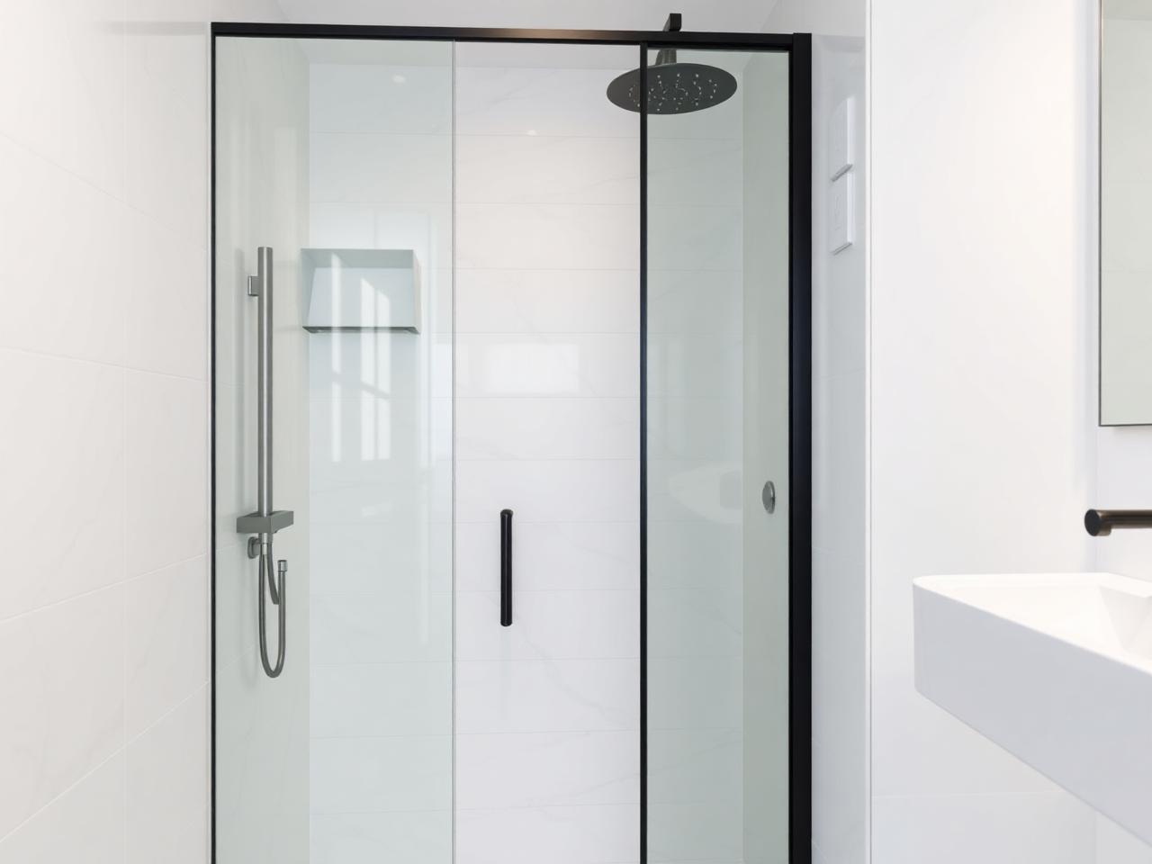 Modern walk-in shower installation Dublin with marble tiles and matte black fittings by RSM Construction